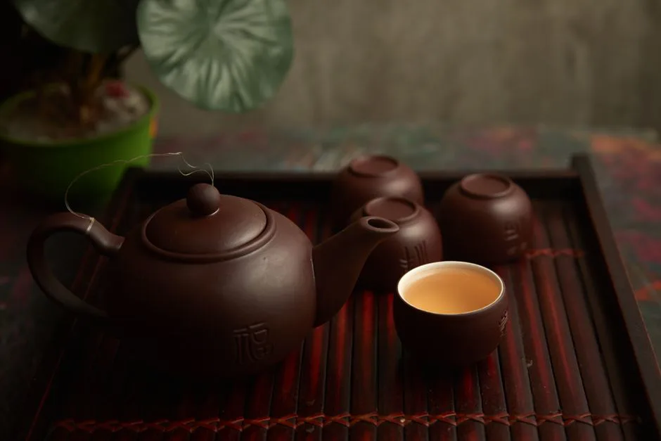Elegant display of a traditional tea set on a wooden tray reflecting a serene tea ceremony ambiance.
