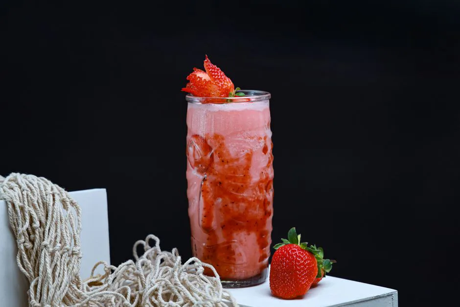 Delicious strawberry smoothie served in a tall glass, perfect for a refreshing summer drink.