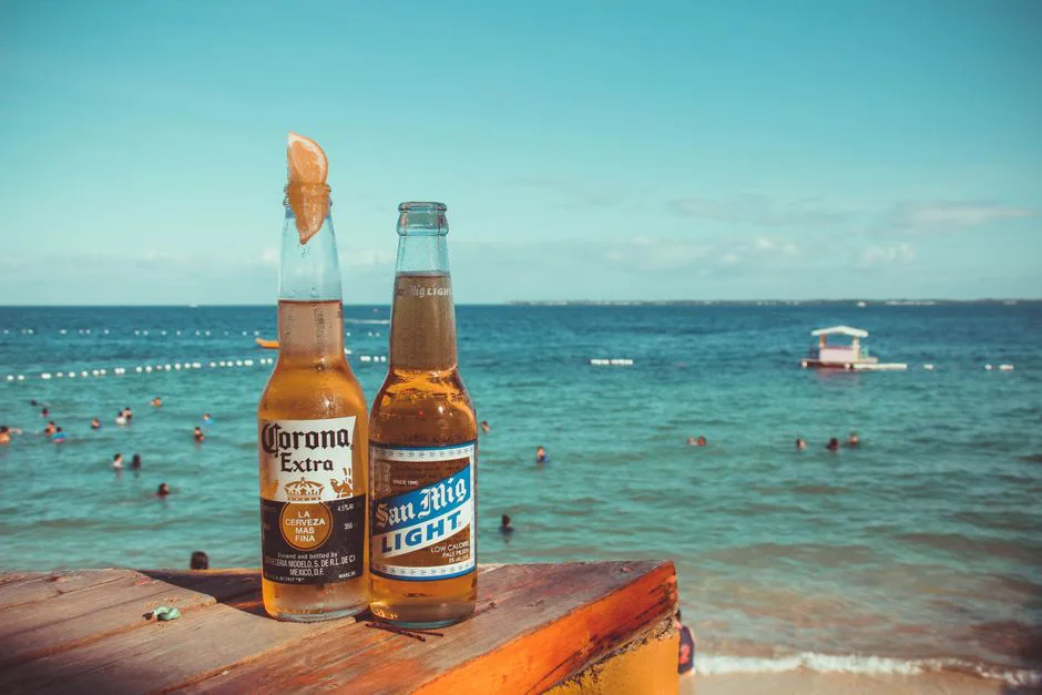 Two cold beers on a table overlooking a tropical beach in Lapu-Lapu City, Philippines.