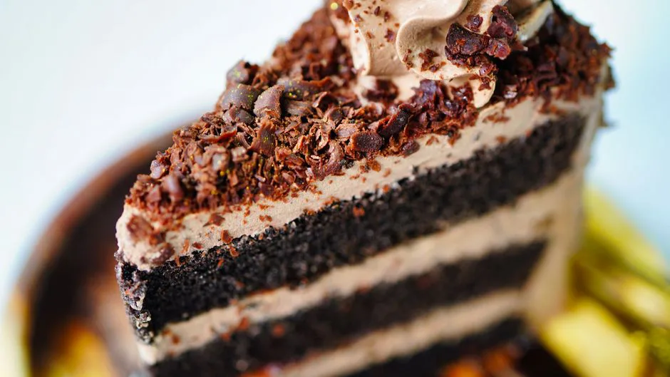 Close-up of a decadent chocolate layer cake with rich frosting, perfect for dessert lovers.