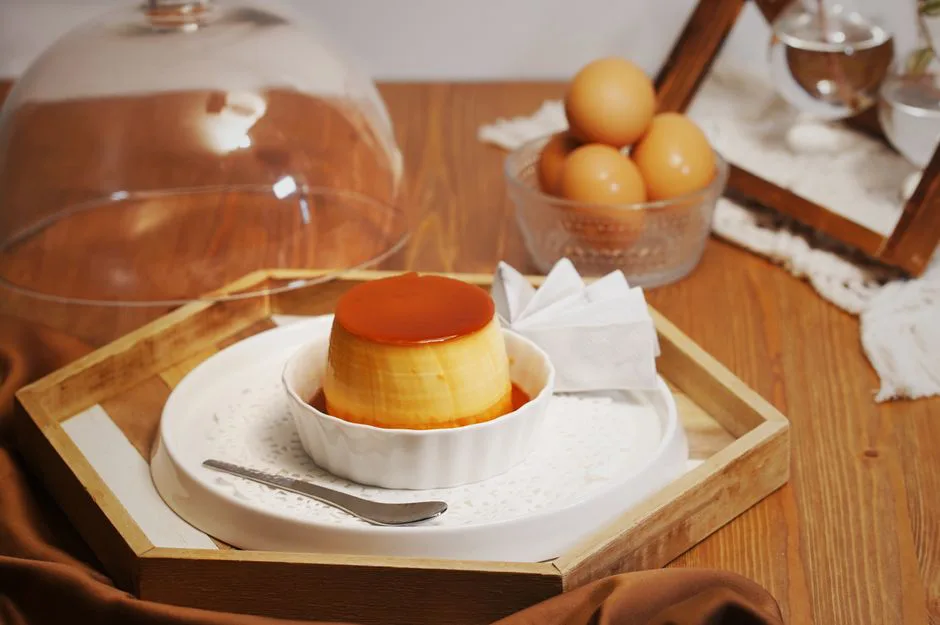 Delicious homemade custard flan with caramel glaze on a wooden tray in a cozy kitchen setting, perfect for dessert lovers.