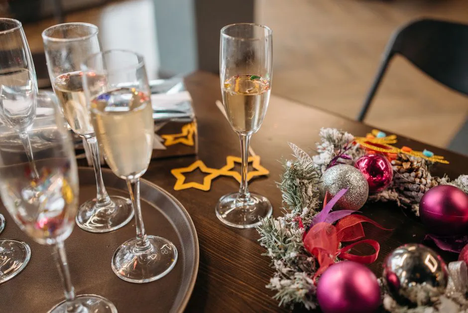 Celebrate the holidays with champagne, festive wreaths, and colorful decorations.