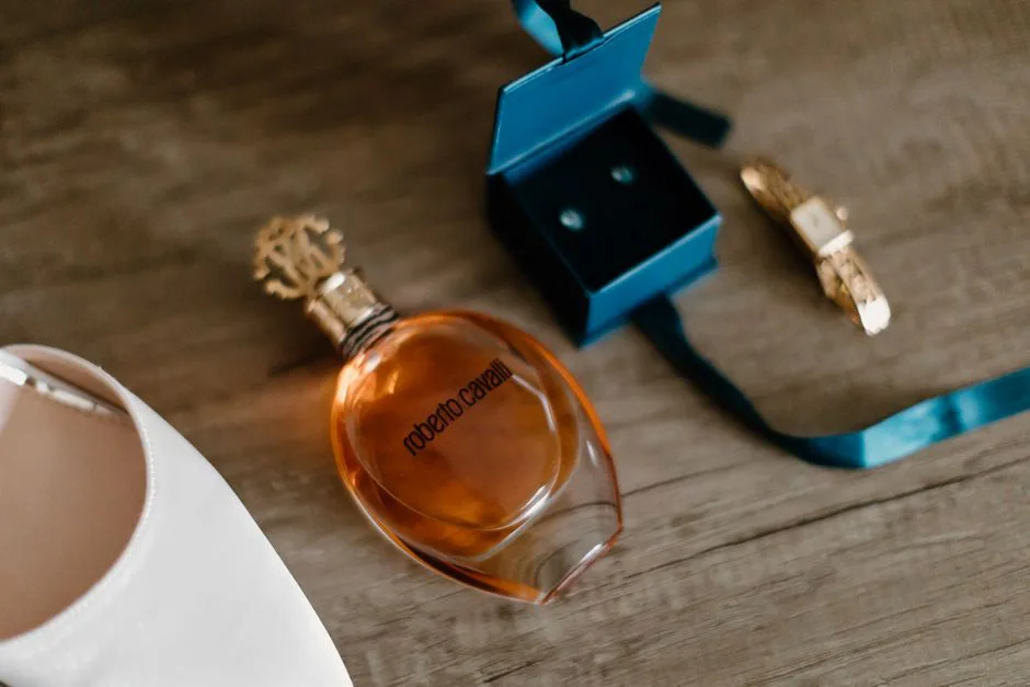 Luxurious flat lay featuring a perfume bottle, jewelry box, and elegant white shoe.