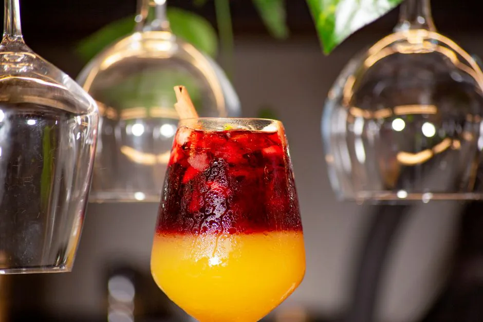 Colorful layered cocktail with ice, perfect for a modern dining experience.
