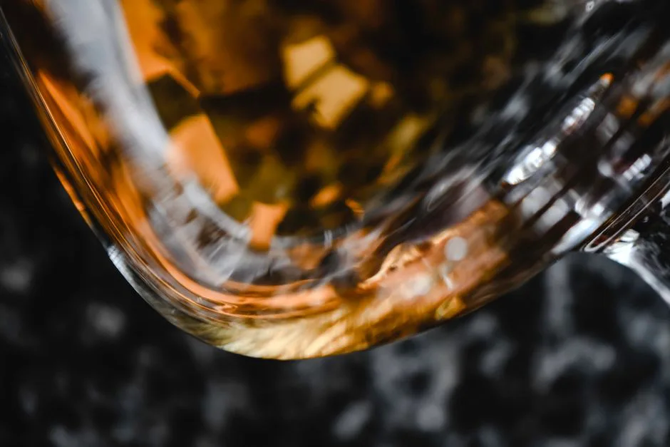 Artistic close-up of whiskey in a glass showcasing warm, golden-brown hues, perfect for drink concepts.
