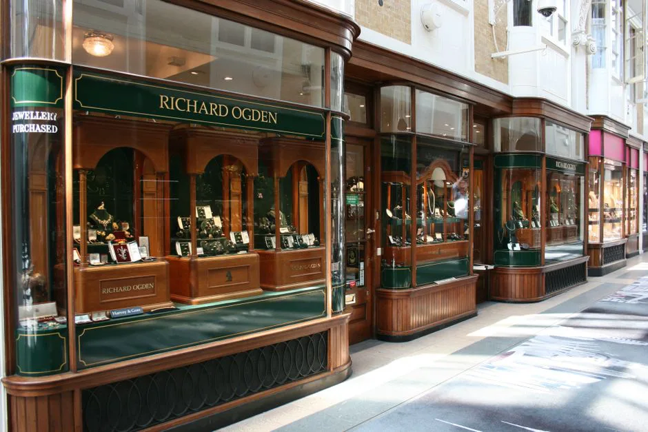 Richard Ogden jewelry storefront showcases luxury items in a historic arcade.
