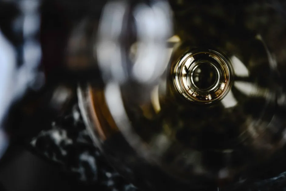 Intriguing abstract view through the bottom of a liquor bottle, showcasing circular reflections.