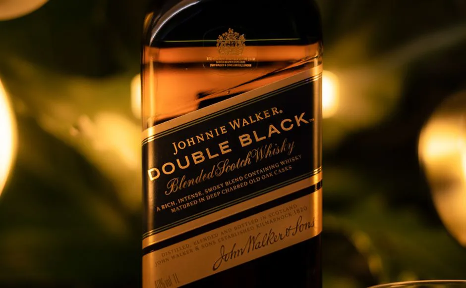 Close-up of a Johnnie Walker Double Black blended Scotch whisky bottle.