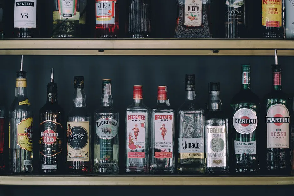 A collection of assorted liquor bottles on a bar shelf, perfect for nightlife or bar themes.